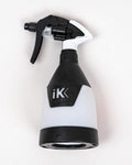 Black and white spray bottle with 'iK' logo on a light gray background