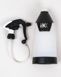 White and black spray bottle with trigger on a light gray background